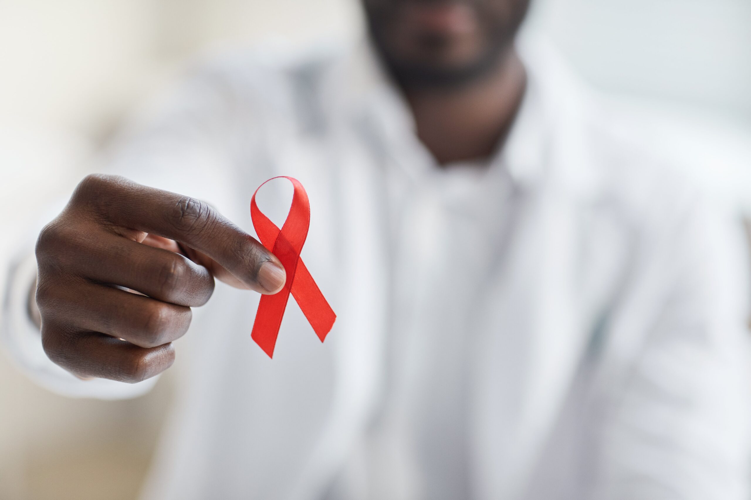 doctor holding the ribbon representing the fight against HIV